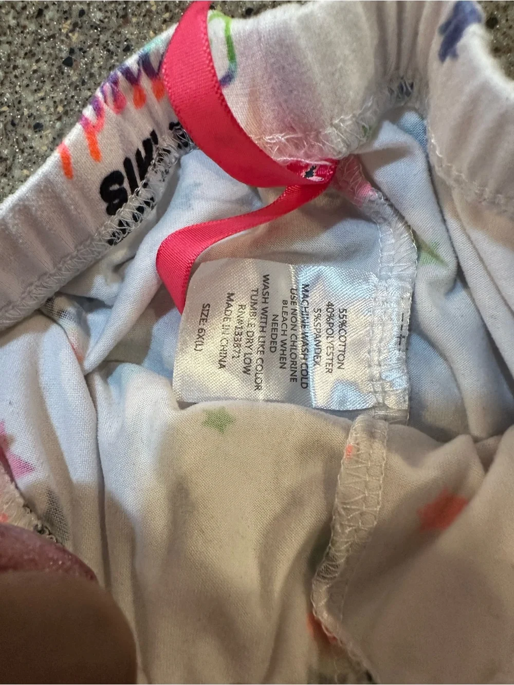 Place White Pajama Bottoms with Multicolor Stars and Text
